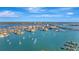 Stunning aerial view of coastal condo building with boat dotted waterways and city skyline at 400 Island Way # 1404, Clearwater Beach, FL 33767