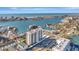 Aerial view of waterfront condo building with marina and ocean views at 400 Island Way # 1404, Clearwater Beach, FL 33767