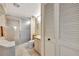 Bathroom featuring a glass shower, tile, and a vanity with storage space at 400 Island Way # 1404, Clearwater Beach, FL 33767