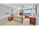 Traditional bedroom with a four-poster bed, water view, and a ceiling fan at 400 Island Way # 1404, Clearwater Beach, FL 33767