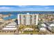 Scenic view of condo building with a large parking area and a pool, nestled on the water at 400 Island Way # 1404, Clearwater Beach, FL 33767