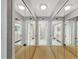 Hallway with mirrored closet doors extending down the hallway and neutral carpet at 400 Island Way # 1404, Clearwater Beach, FL 33767