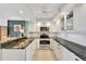 Modern kitchen boasts granite countertops, white cabinets, and stainless steel appliances for a sleek design at 400 Island Way # 1404, Clearwater Beach, FL 33767