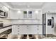 Bright kitchen with updated cabinets, black countertops, and stainless steel refrigerator at 400 Island Way # 1404, Clearwater Beach, FL 33767