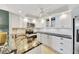 Updated kitchen with stainless steel appliances, black countertops, and stylish white cabinets at 400 Island Way # 1404, Clearwater Beach, FL 33767