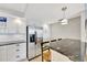 Contemporary kitchen featuring stainless steel appliances, granite counters, a breakfast bar, and bright lighting at 400 Island Way # 1404, Clearwater Beach, FL 33767