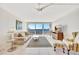Bright living room with sliding glass doors to balcony showcasing water views and comfortable seating arrangement at 400 Island Way # 1404, Clearwater Beach, FL 33767