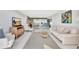 Open living space with comfortable seating arrangement, modern entertainment unit and access to the kitchen and dining area at 400 Island Way # 1404, Clearwater Beach, FL 33767