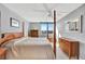Bedroom with wood furniture set and a large window offering scenic water views at 400 Island Way # 1404, Clearwater Beach, FL 33767