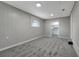 Bright basement room featuring gray walls and carpet at 40242 Sunburst Dr, Dade City, FL 33525