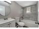 Clean bathroom with gray tile and white vanity at 40242 Sunburst Dr, Dade City, FL 33525