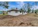 Side view of a newly renovated home, showcasing its clean lines and landscaping at 40242 Sunburst Dr, Dade City, FL 33525