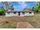 Newly renovated single story home with a modern exterior and landscaped yard at 40242 Sunburst Dr, Dade City, FL 33525