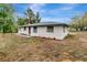 Side view of a charming ranch-style home showcasing its newly renovated exterior at 40242 Sunburst Dr, Dade City, FL 33525