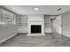 Stone fireplace with built in shelving on either side, in a living room with gray walls at 40242 Sunburst Dr, Dade City, FL 33525