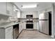 Modern kitchen with white cabinets, stainless steel appliances, and granite countertops at 40242 Sunburst Dr, Dade City, FL 33525