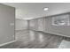 Bright living room with grey vinyl flooring and access to other rooms at 40242 Sunburst Dr, Dade City, FL 33525