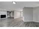 Living room with fireplace and built in shelving, gray walls and gray laminate floors at 40242 Sunburst Dr, Dade City, FL 33525