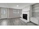 Living room with fireplace, built-in shelving, and grey vinyl flooring at 40242 Sunburst Dr, Dade City, FL 33525