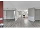 Bright and airy living room featuring gray laminate floors and a view into the kitchen at 40242 Sunburst Dr, Dade City, FL 33525