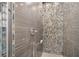 Walk-in shower with glass shelves and modern tile at 4544 Oak River Cir, Valrico, FL 33596