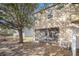 Exterior view of the home showcasing a screened-in patio, lawn and leafy mature tree at 5038 White Sanderling Ct, Tampa, FL 33619