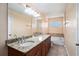 Bathroom features double sinks, granite countertops, and a soaking tub for a relaxing experience at 5038 White Sanderling Ct, Tampa, FL 33619