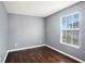 Bright bedroom featuring hardwood floors, a window, and neutral gray paint at 5038 White Sanderling Ct, Tampa, FL 33619