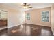 Bright, spacious bedroom with hardwood floors, two windows, and an ensuite bathroom at 5038 White Sanderling Ct, Tampa, FL 33619