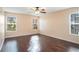 Sun-filled bedroom with hardwood floors and two large windows provides ample natural light at 5038 White Sanderling Ct, Tampa, FL 33619