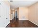 Upstairs hallway with dark laminate floors, neutral paint and natural light at 5038 White Sanderling Ct, Tampa, FL 33619