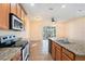 Stylish kitchen featuring granite counters, modern appliances, and tile flooring at 5038 White Sanderling Ct, Tampa, FL 33619