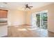 Open floorplan living area offers tile floors and sliding glass doors to screened patio at 5038 White Sanderling Ct, Tampa, FL 33619