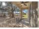 Relaxing screened porch with ceiling fan offers outdoor views of the landscaped yard and mature tree at 5038 White Sanderling Ct, Tampa, FL 33619