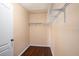 Spacious walk-in closet featuring hardwood floors and ample storage with wire shelving at 5038 White Sanderling Ct, Tampa, FL 33619