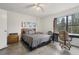 Bedroom with large window, ceiling fan and wood dresser at 5328 Ridgewell Ct, Tampa, FL 33624