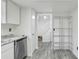 Kitchen with stainless steel appliances, white cabinets, granite countertop, and staircase nearby at 5328 Ridgewell Ct, Tampa, FL 33624