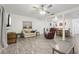 Open floor plan of living room with ceiling fan, gray floors, comfortable seating, and dining area at 5328 Ridgewell Ct, Tampa, FL 33624