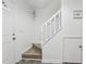 Staircase with white banister and neutral flooring in a well-lit entryway at 5328 Ridgewell Ct, Tampa, FL 33624