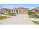 House exterior view showcasing a two-car garage and a neatly landscaped front yard at 6314 Roadstead Ct, Apollo Beach, FL 33572