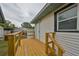 Elevated wooden deck with access to backyard and shed at 723 Ornelda Sw St, Ruskin, FL 33570