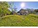 Large grassy backyard with mature trees and shed at 723 Ornelda Sw St, Ruskin, FL 33570