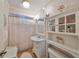 Clean bathroom with white vanity and a glass-front cabinet at 723 Ornelda Sw St, Ruskin, FL 33570