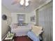 Cozy bedroom with daybed, armchair, and window coverings at 723 Ornelda Sw St, Ruskin, FL 33570