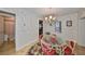 Bright dining room with a charming chandelier and floral-patterned wallpaper at 723 Ornelda Sw St, Ruskin, FL 33570