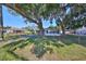 House with large tree and chain link fence at 723 Ornelda Sw St, Ruskin, FL 33570