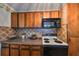 Kitchen with wood cabinets, a stove, and a microwave at 723 Ornelda Sw St, Ruskin, FL 33570
