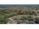 Aerial view showcasing condo building near a pond and lush trees at 8647 Fancy Finch Dr # 203, Tampa, FL 33614