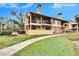 Two-story condo building with brick and siding, walkways, and landscaping at 8647 Fancy Finch Dr # 203, Tampa, FL 33614