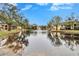 Tranquil community pond with fountain, reflecting buildings and lush trees at 8647 Fancy Finch Dr # 203, Tampa, FL 33614